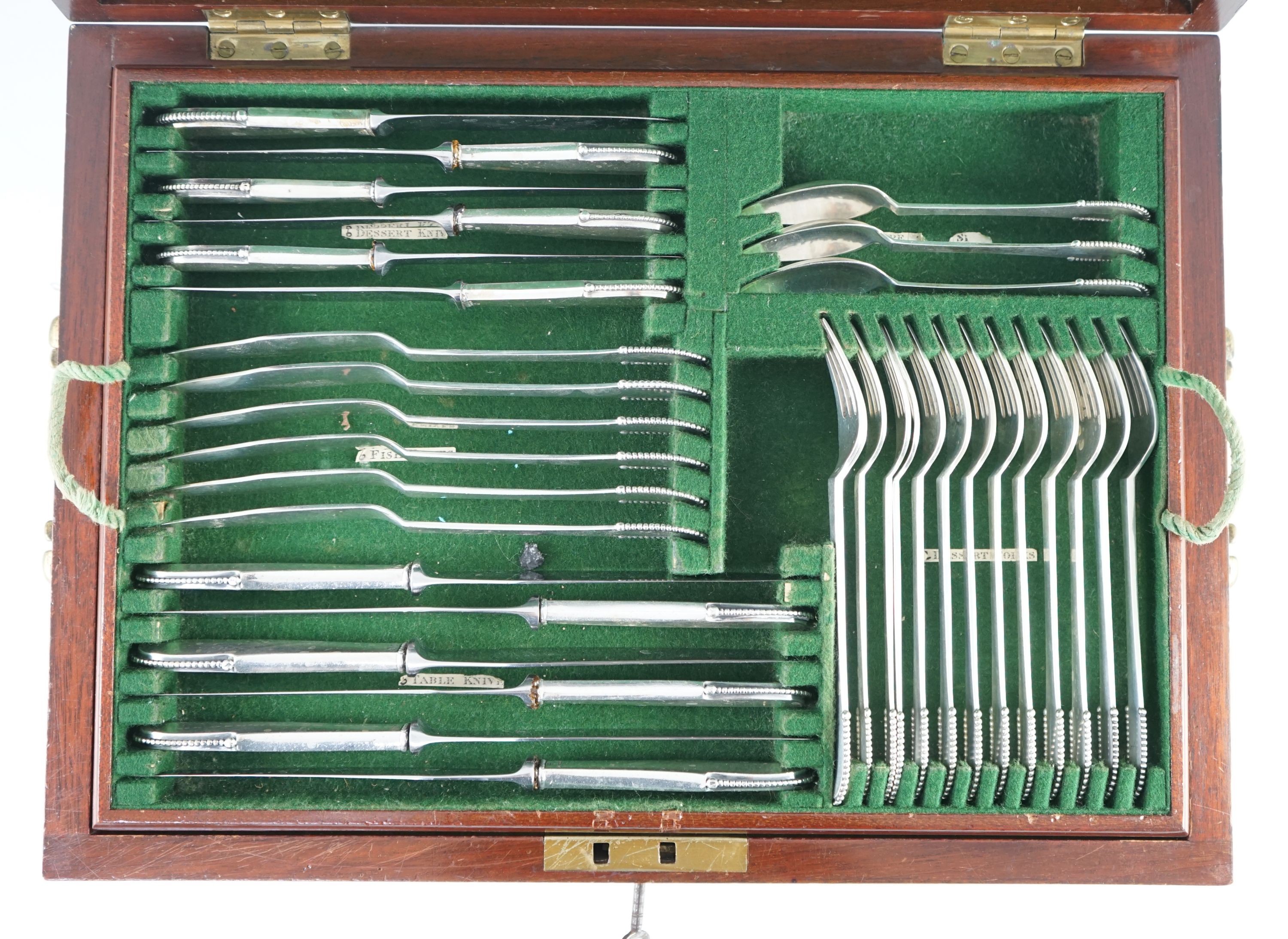 An early 20th century Georg Jensen canteen of beaded pattern silver cutlery